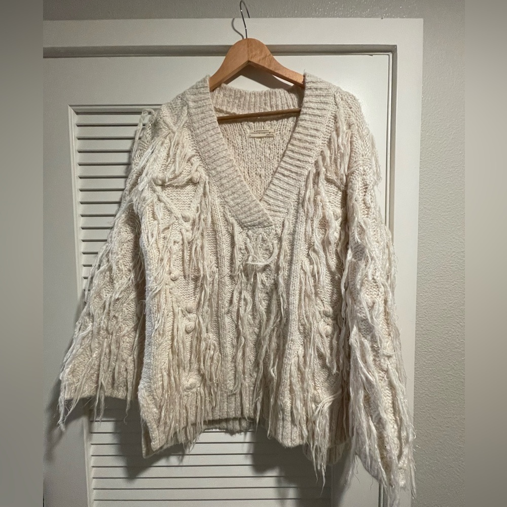 White party sweater with gold and fringe detail